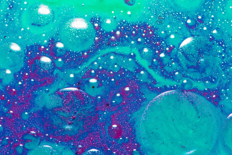 water and bubbles are mixed in on a blue surface
