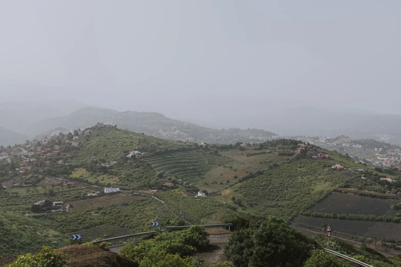 a scenic view of a village is shown from the mountains