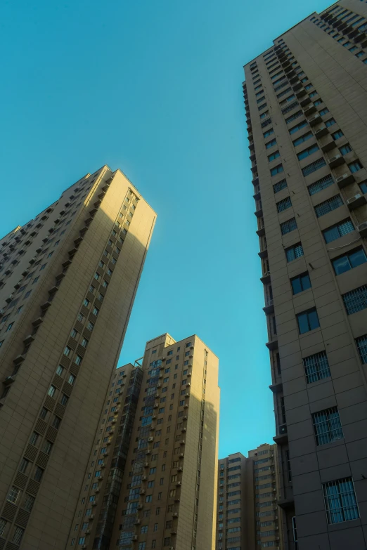 a row of buildings looking up into the sky