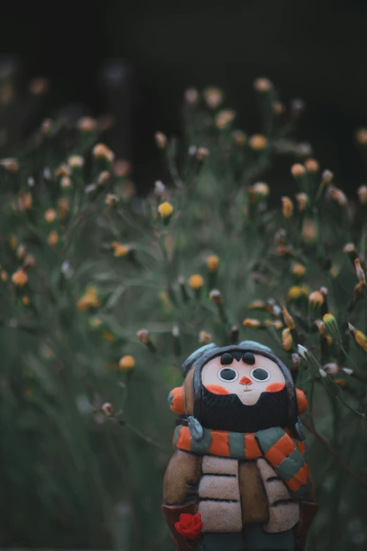 a sculpture sits amongst the flowers in a field