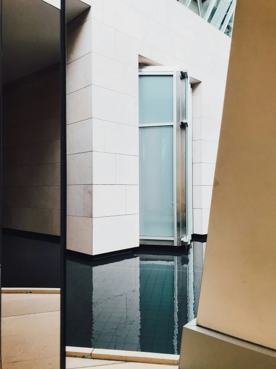 the entrance to a building next to a pool