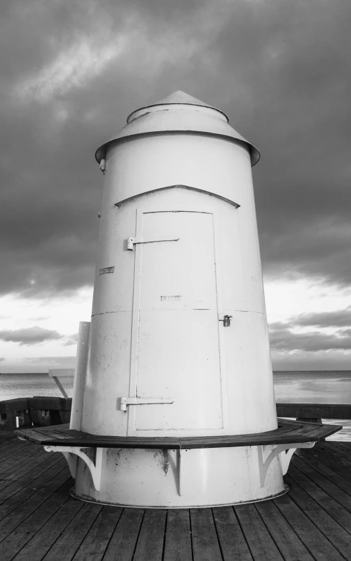 a large white tower sitting on top of a wooden floor