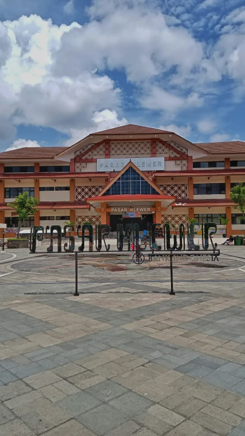 people are walking around in front of a large building