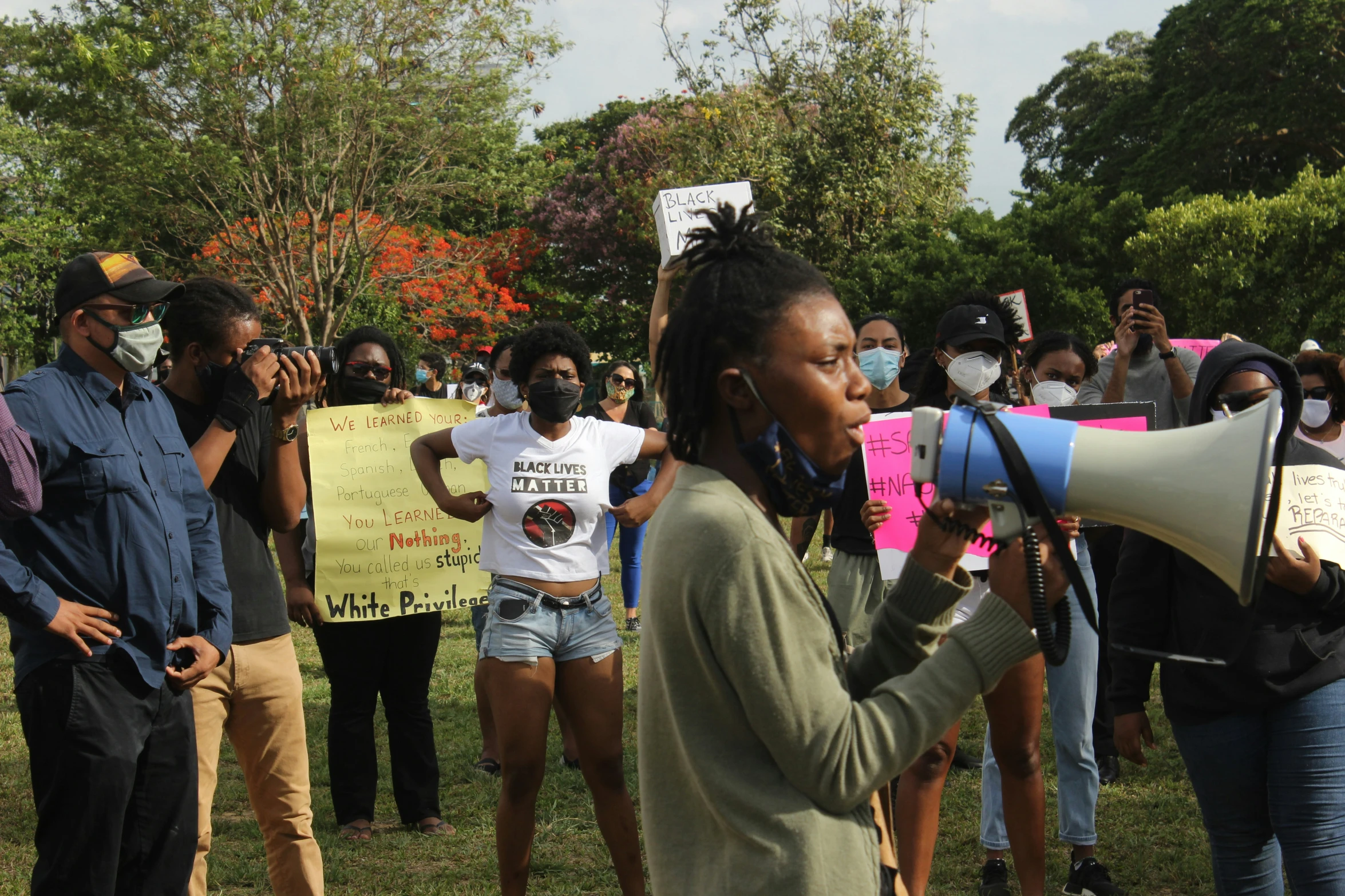 an individual takes a picture of the protest