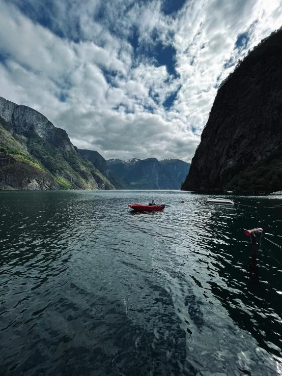 the small boat is anchored in the water