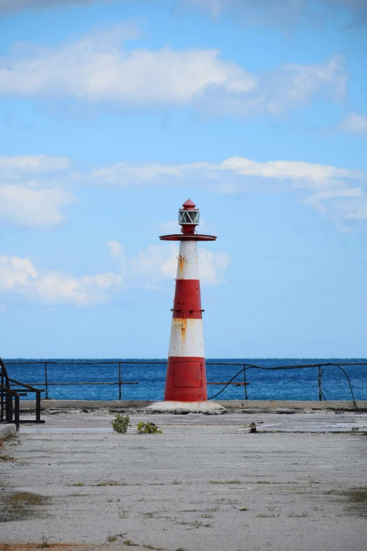 an image of a lighthouse out by the ocean