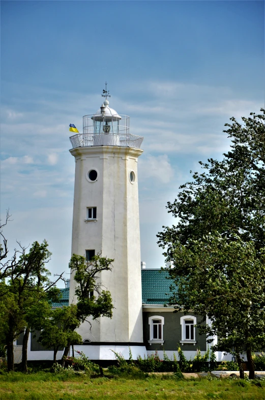 the white lighthouse is located in a field