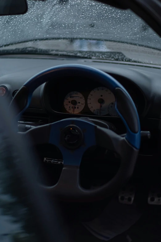 a dashboard view inside the car, showing the gauges