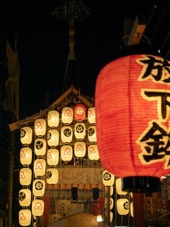 paper lanterns on display over a street at night