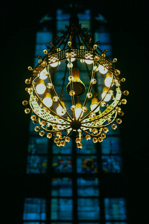 a clock and some lights hanging from the ceiling