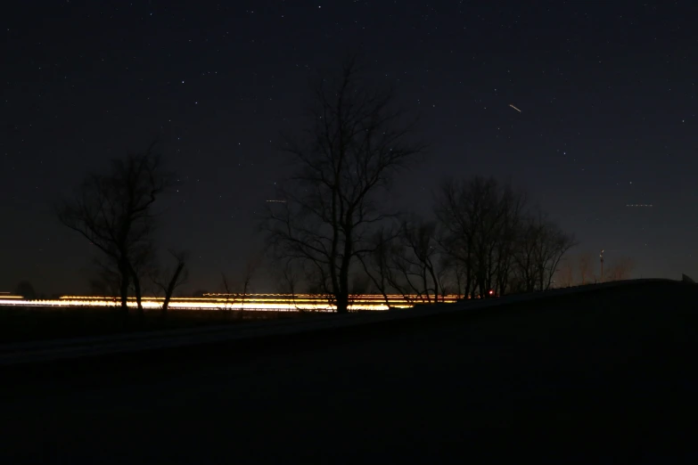 a view of a hill and some trees at night