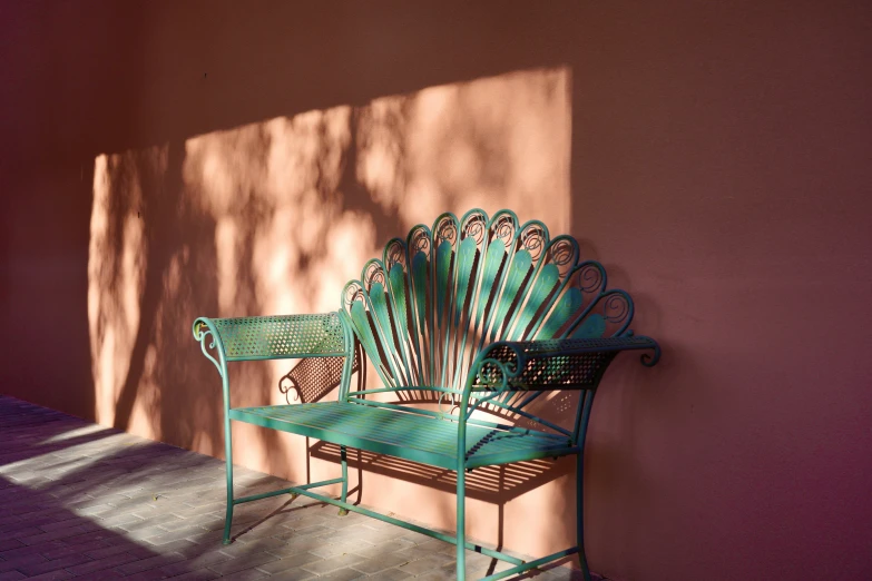 the back of a green bench next to a bench