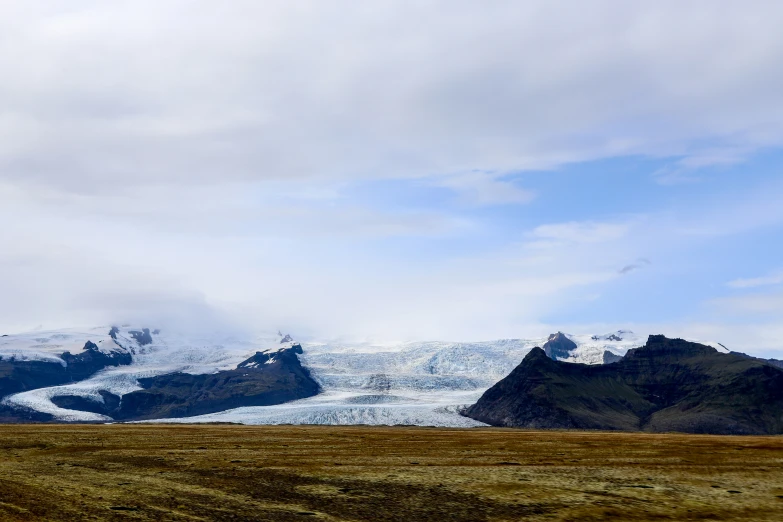 a large snow covered mountain in the distance