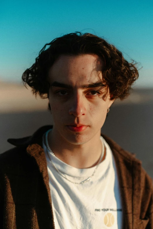 a person standing with long dark curly hair