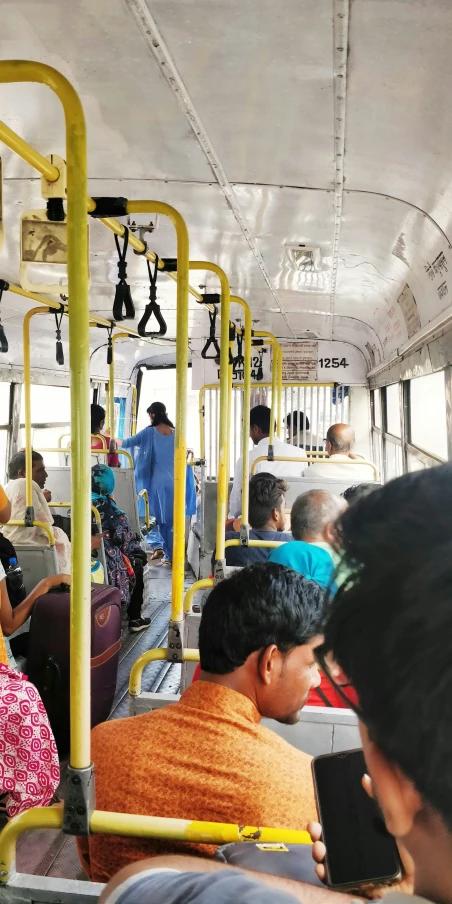 people sit on the back of a public transit bus