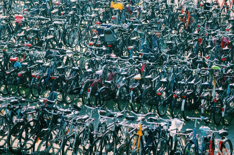 a group of bikes parked next to each other in a parking lot
