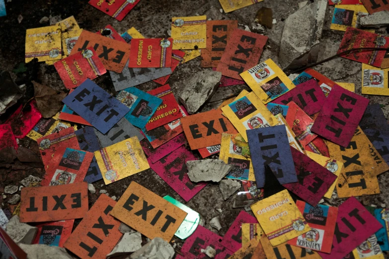 many different colorful papers sitting on the ground