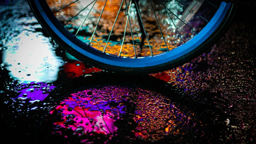 a close up of a bicycle tire on wet pavement