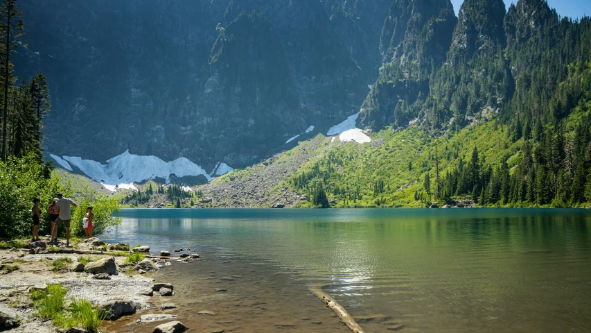 two boats are parked near a mountain lake