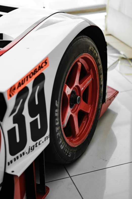 a very nice racing car painted bright red and white