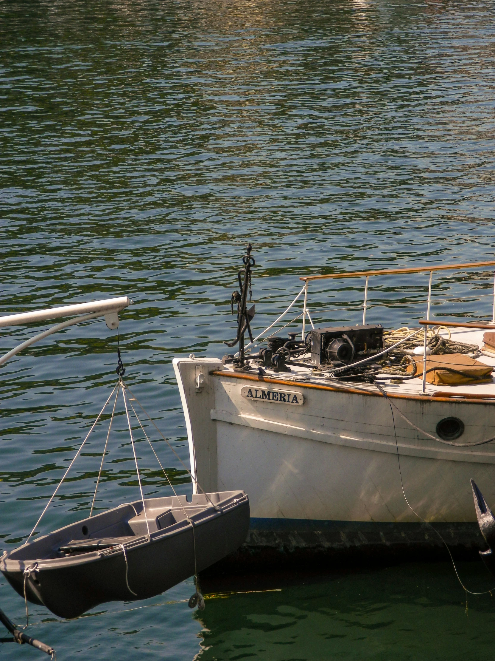 a small white boat tied up to the dock