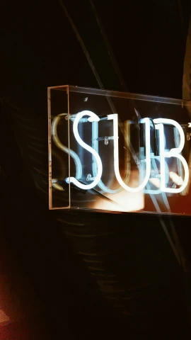a neon sign with the word subway written underneath it