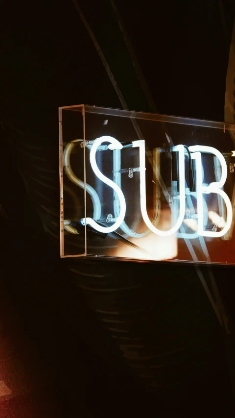 a neon sign with the word subway written underneath it