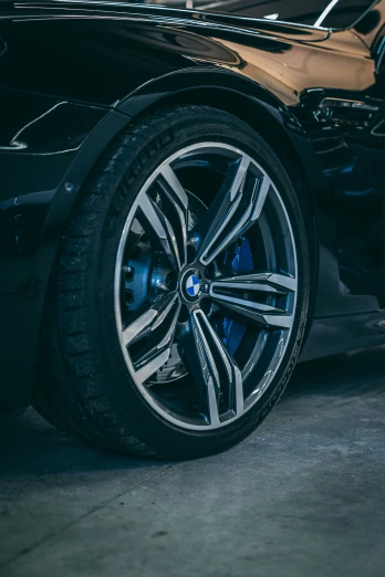 a close up s of the rims on a black sports car