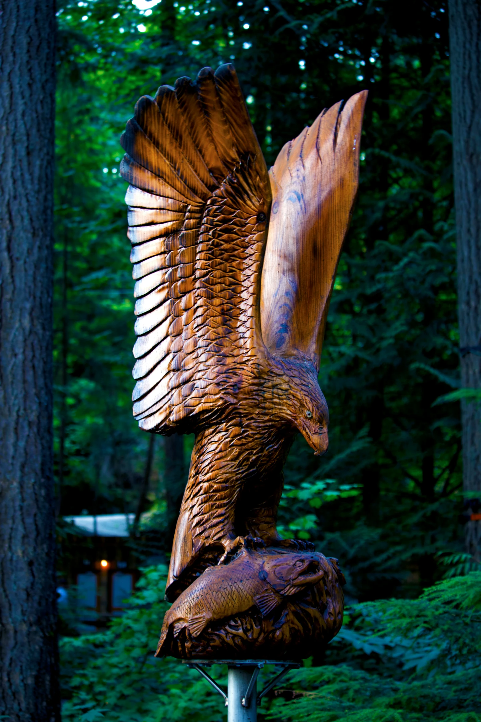 a wooden sculpture of an eagle on a stick