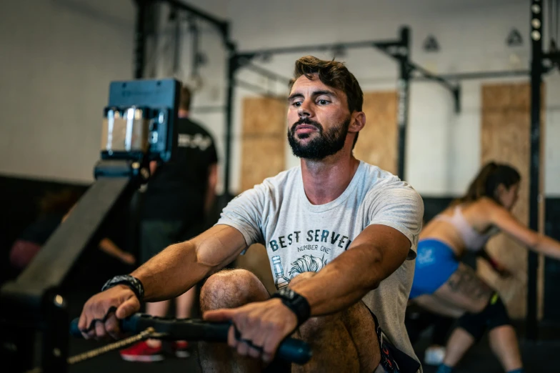 a man sitting on the floor working out in the gym