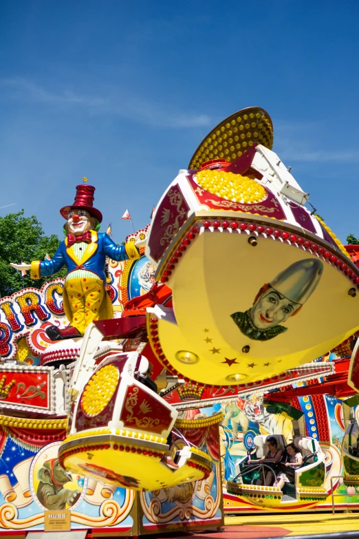 an assortment of brightly colored carnival floats in front of a blue sky