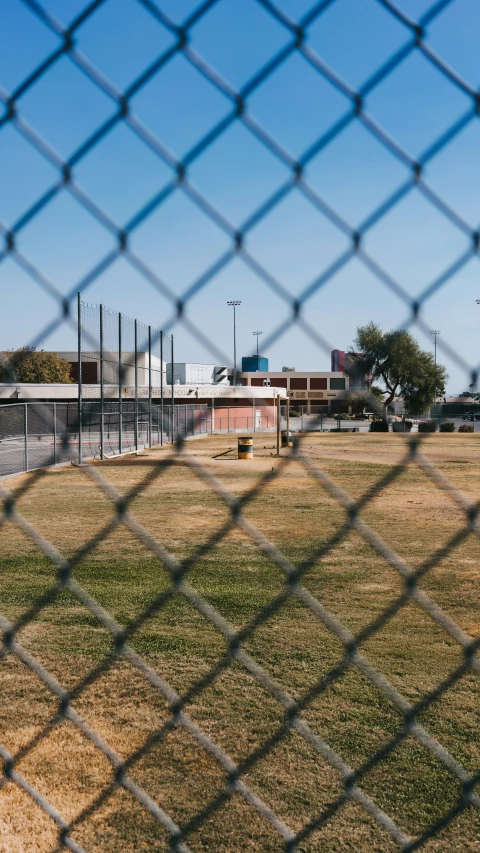 a building seen through a chain link fence