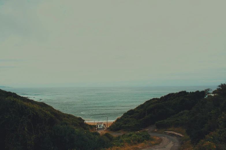 an ocean view of the beach and trees