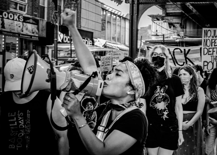 people at an anti - fraunnut rally with megaphones