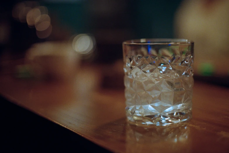 a glass sitting on top of a wooden table