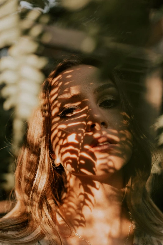 a young woman with sun shining through her face