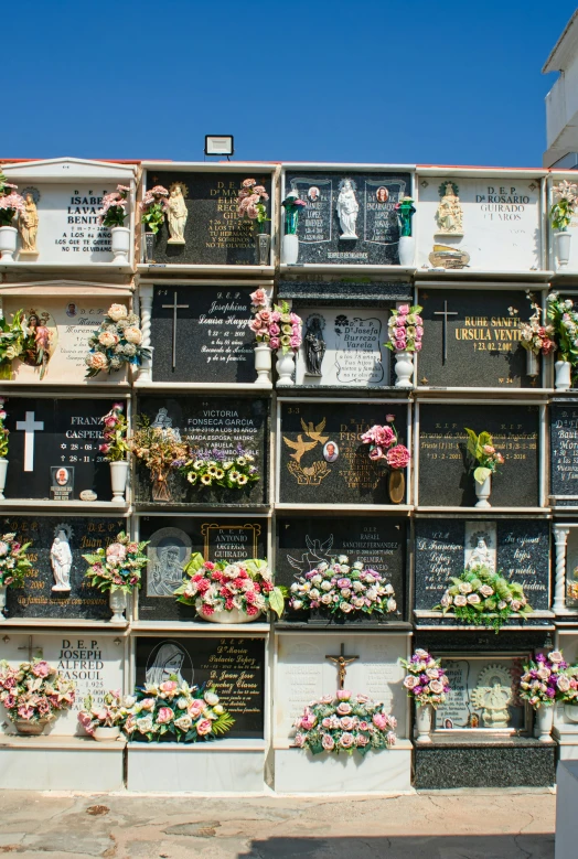 a large memorial with flowers and pictures all over it