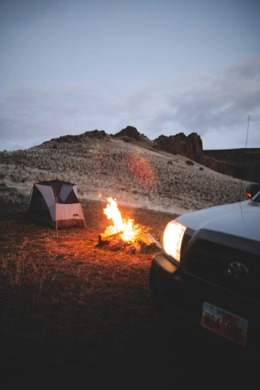 a view of a camp site with two tents around it