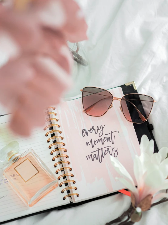 a notebook that says very important mothers next to some sunglasses and a pink flower