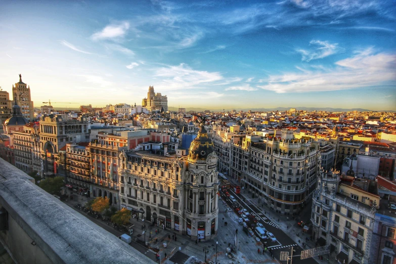 city buildings with many spires against a cloudy sky