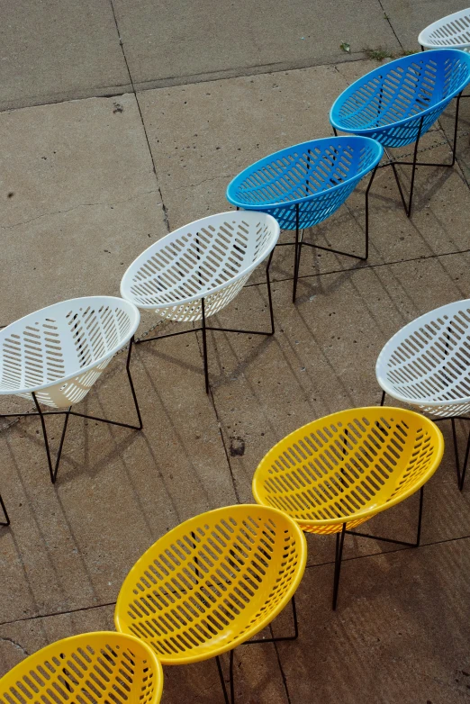 four round table sitting on the pavement with small tables with circular sides