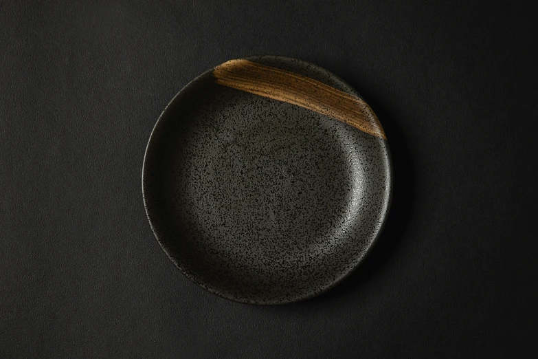 a plate with a black edge on a table
