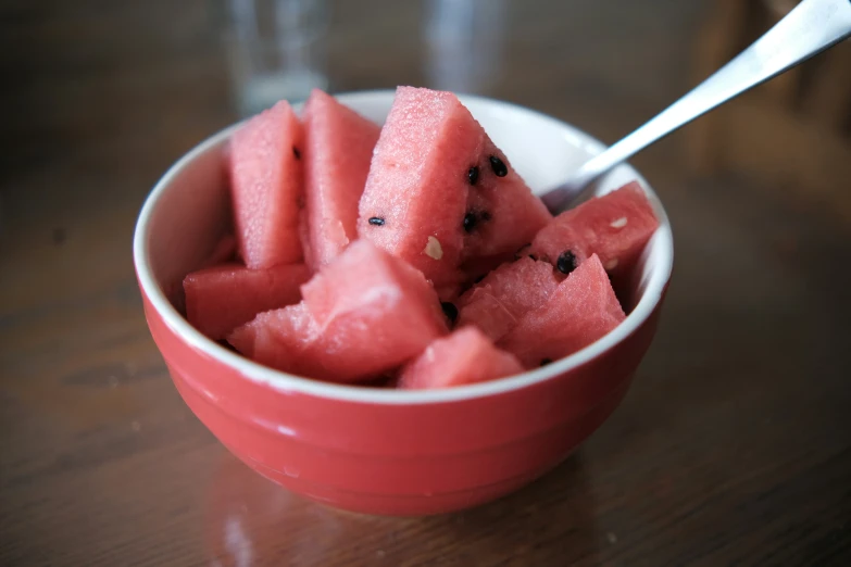 there are many slices of watermelon and some strawberries in this bowl