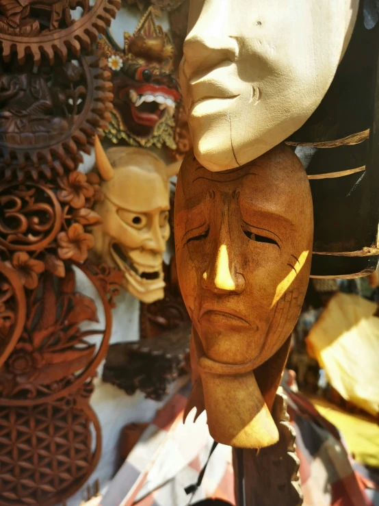 a mask with a face and several different other sculptures