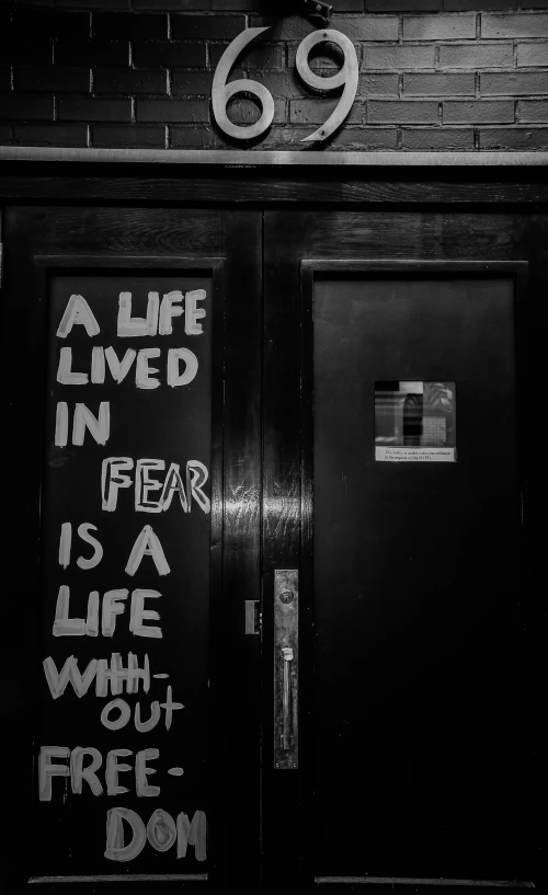 black and white pograph of the door with graffiti
