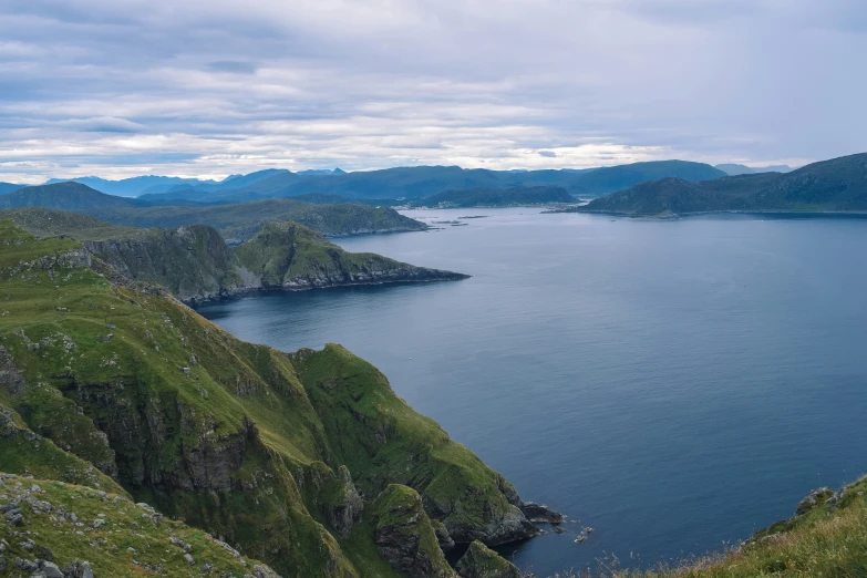 the view of some very green hills and water