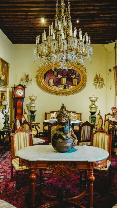 a room with an ornate chandelier and many mirrors