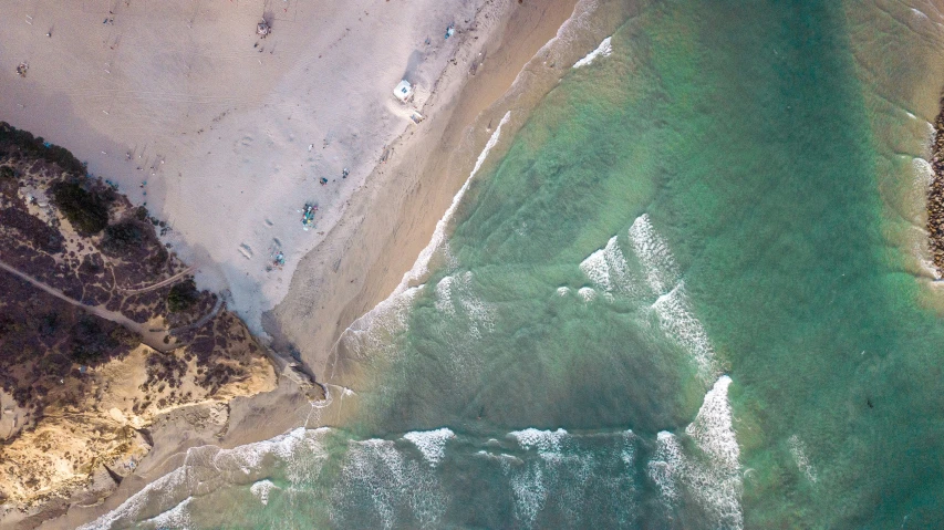 an aerial view of people in the ocean