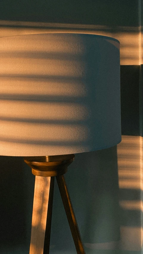 a wooden lamp with a shade over it