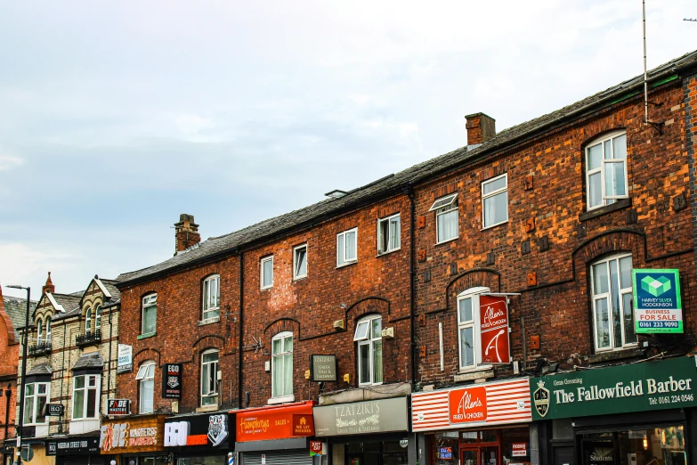 several buildings line the streets in an area with shops and store fronts